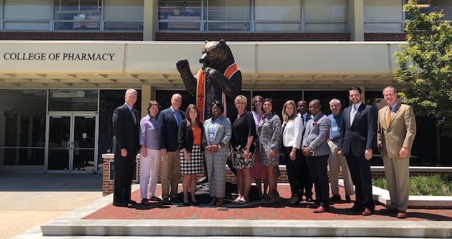 The Board of Directors standing aside the bear statue