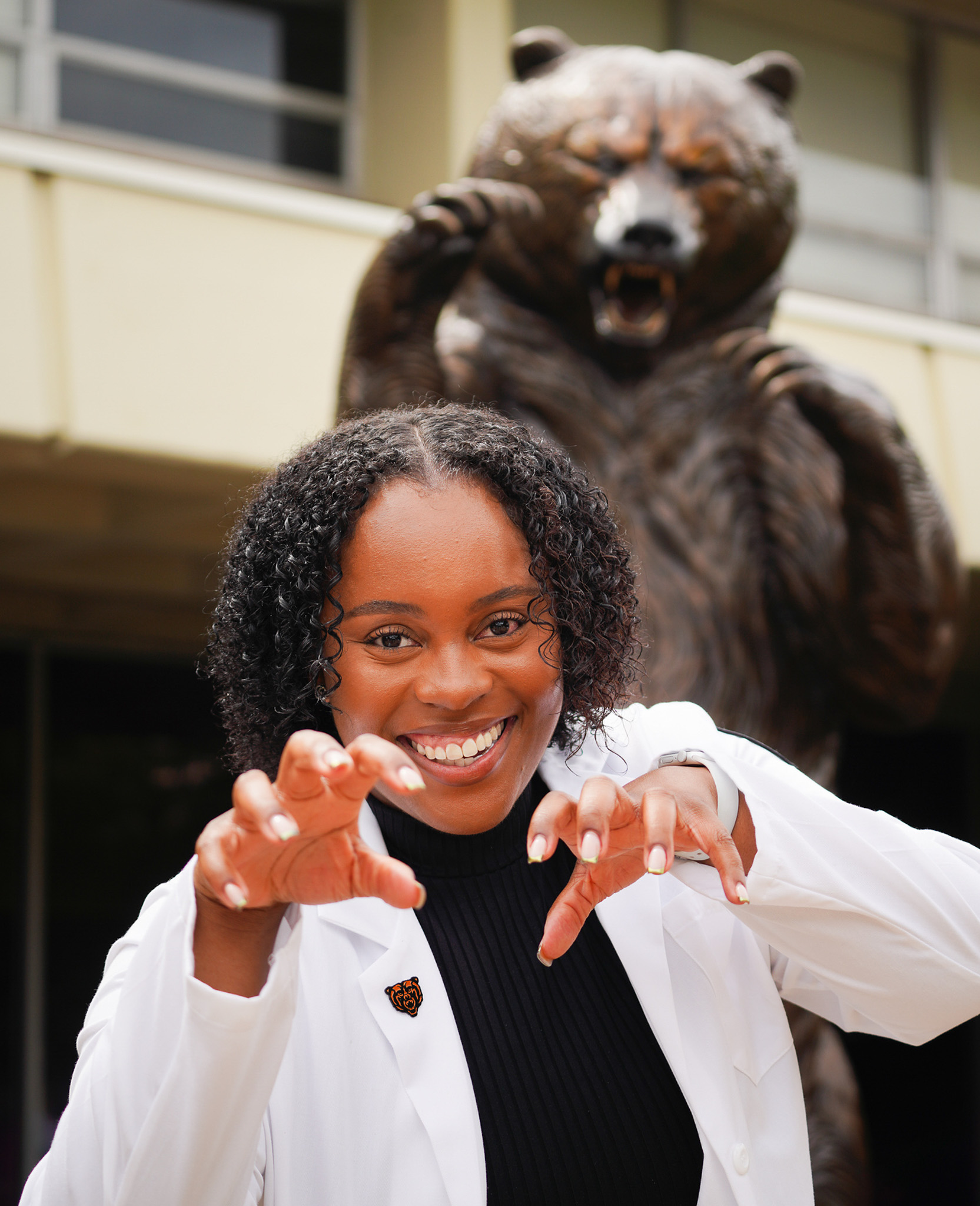 mercer pharmacy student in front of the bear statue. Atlanta, GA