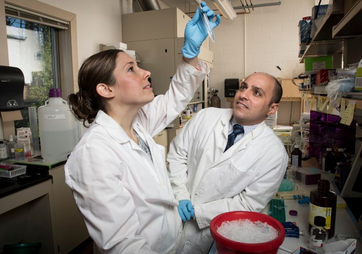 Dr. Nader Moniri looking at a student working in the lab
