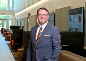 Dean Crouch standing in the hallway of the Mercer Health Sciences Center.